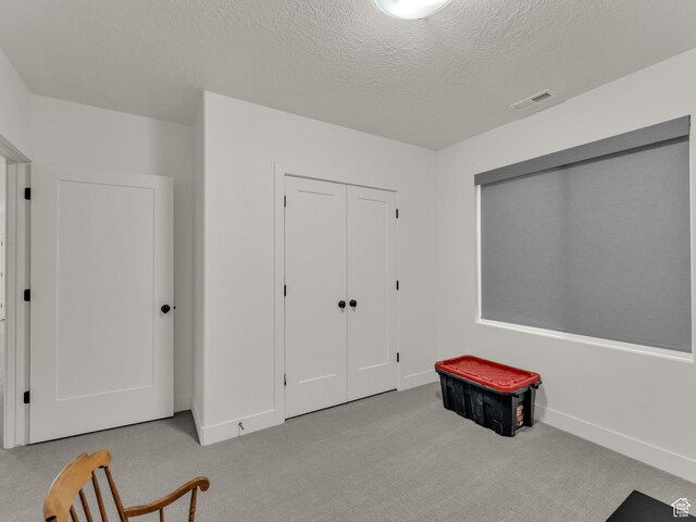 11609 S Dorian Dr W, South Jordan, UT 84009 - unfurnished bedroom featuring carpet flooring, a textured ceiling, and a closet