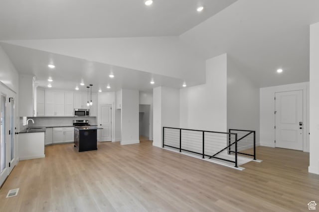 168 N 870 E, Tremonton, UT 84337 - kitchen featuring appliances with stainless steel finishes, dark countertops, white cabinets, a center island, and recessed lighting