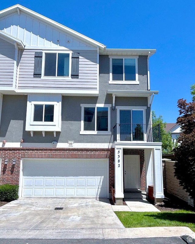 5382 W Tioga Pl, Herriman, UT 84096 - view of front facade featuring stucco siding, brick siding, concrete driveway, and a garage