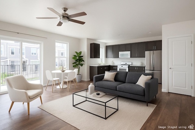 5382 W Tioga Pl, Herriman, UT 84096 - living area with healthy amount of natural light, dark wood finished floors, and ceiling fan