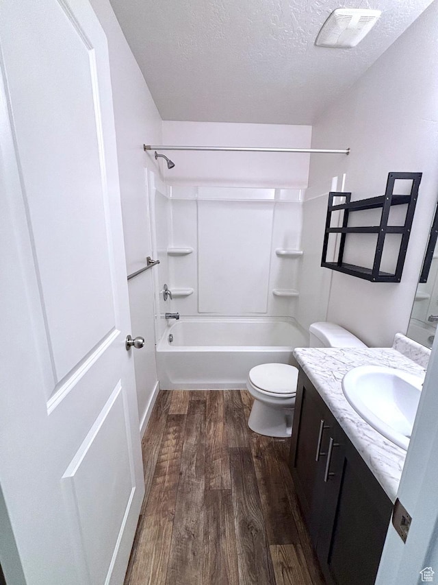 5382 W Tioga Pl, Herriman, UT 84096 - bathroom with vanity, wood finished floors, bathing tub / shower combination, and a textured ceiling
