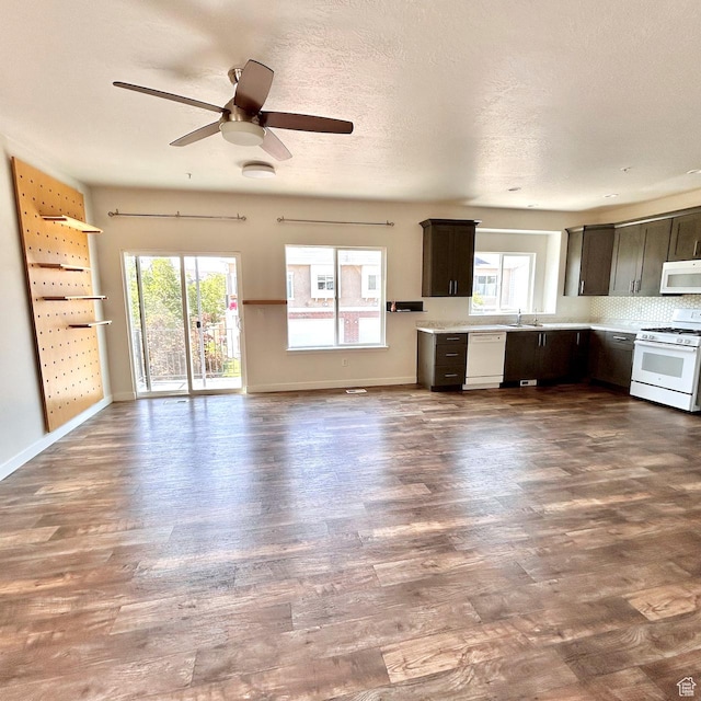 5382 W Tioga Pl, Herriman, UT 84096 - kitchen with white appliances, dark wood-type flooring, light countertops, a ceiling fan, and decorative backsplash