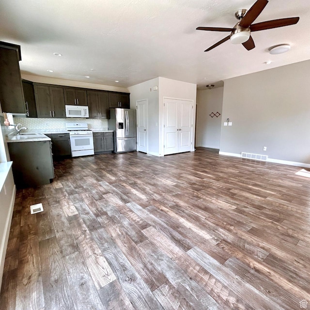 5382 W Tioga Pl, Herriman, UT 84096 - kitchen with white appliances, a ceiling fan, open floor plan, wood finished floors, and light countertops