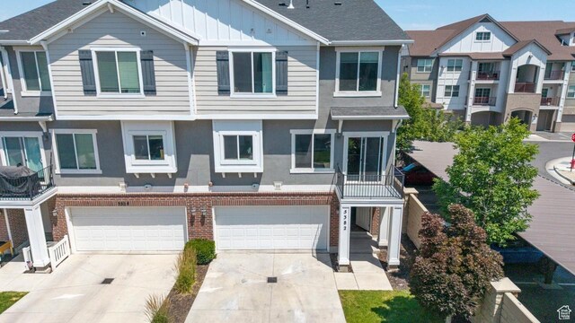 5382 W Tioga Pl, Herriman, UT 84096 - view of property with a garage, board and batten siding, concrete driveway, and stucco siding