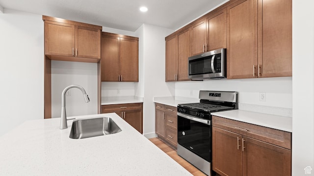 1068 E 1930 S Unit 421, Heber City, UT 84032 - kitchen featuring stainless steel appliances, light countertops, light wood-style flooring, recessed lighting, and brown cabinets