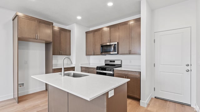 1068 E 1930 S Unit 421, Heber City, UT 84032 - kitchen featuring stainless steel appliances, light wood-style floors, light countertops, a center island with sink, and recessed lighting