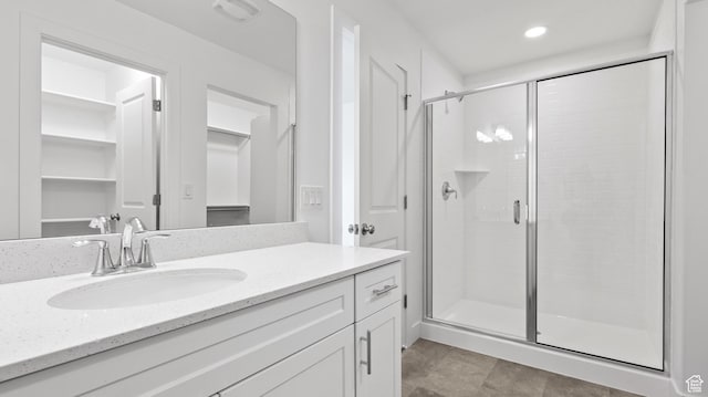 1068 E 1930 S Unit 421, Heber City, UT 84032 - bathroom with vanity, a shower stall, a walk in closet, and recessed lighting