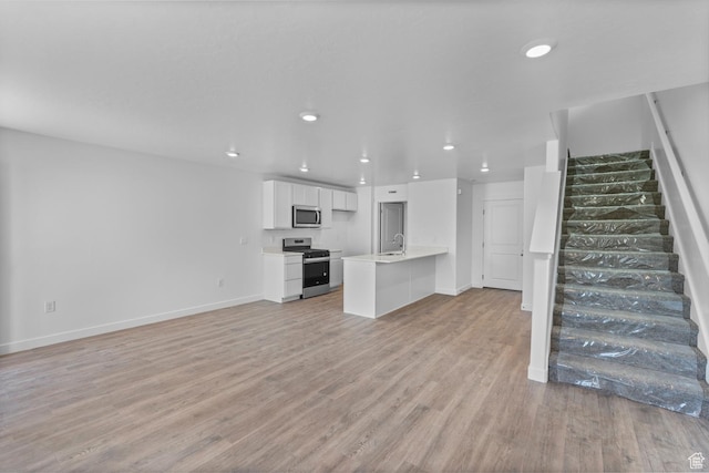 1557 E 720 N Unit 1070, Salem, UT 84653 - unfurnished living room with stairway, light wood-type flooring, and recessed lighting