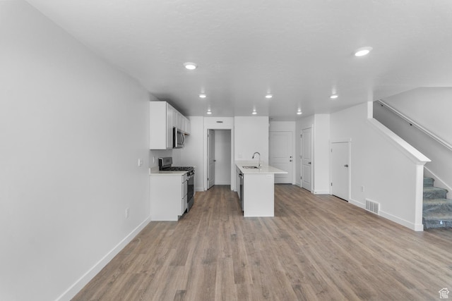 1557 E 720 N Unit 1070, Salem, UT 84653 - kitchen featuring stainless steel appliances, light countertops, light wood-style flooring, white cabinetry, and recessed lighting