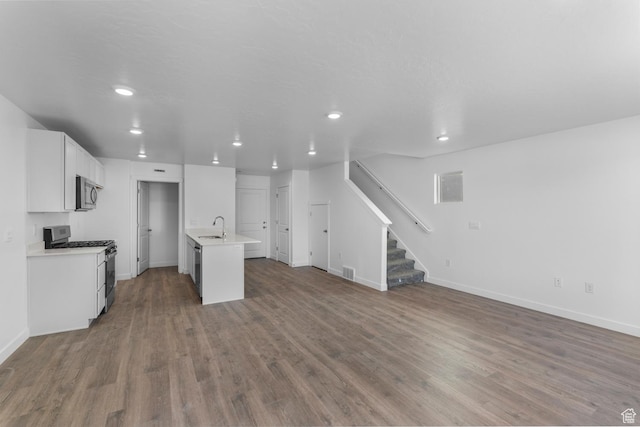 1557 E 720 N Unit 1070, Salem, UT 84653 - unfurnished living room with wood finished floors, stairs, and recessed lighting