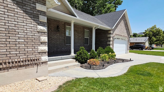 65 E 300 S, Salina, UT 84654 - view of side of home with a garage, driveway, covered porch, a shingled roof, and brick siding