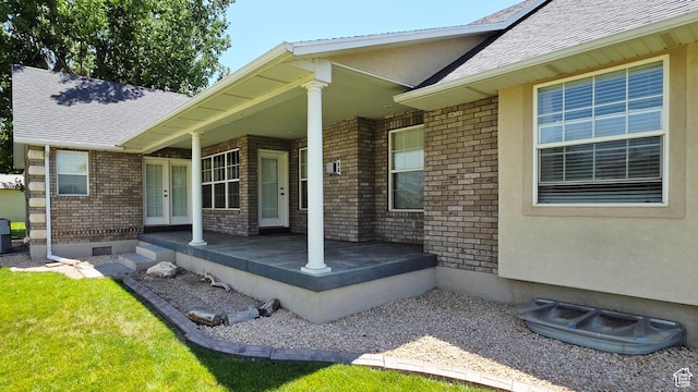 65 E 300 S, Salina, UT 84654 - doorway to property featuring french doors, a porch, roof with shingles, and brick siding