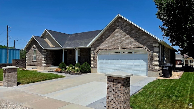 65 E 300 S, Salina, UT 84654 - view of front of house featuring driveway, an attached garage, a front yard, and brick siding