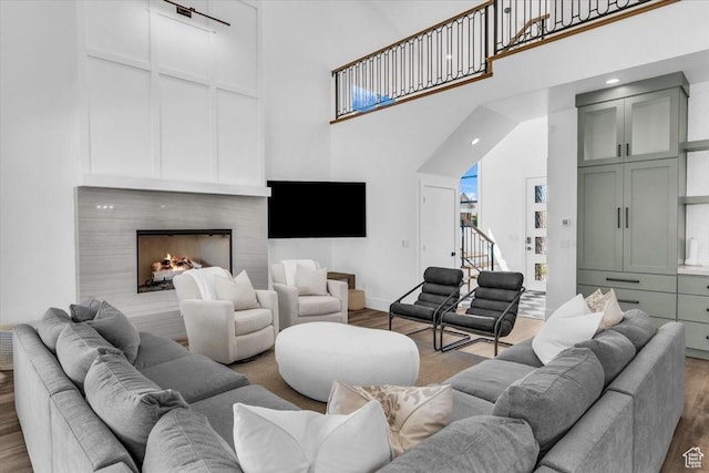 772 E Prairie Way, Washington, UT 84780 - living area with a towering ceiling, wood finished floors, a warm lit fireplace, and stairway