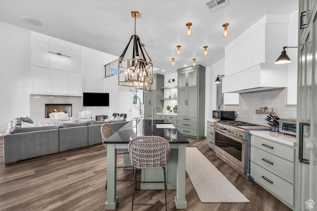 772 E Prairie Way, Washington, UT 84780 - kitchen featuring stainless steel appliances, tasteful backsplash, a kitchen breakfast bar, dark wood finished floors, and decorative light fixtures