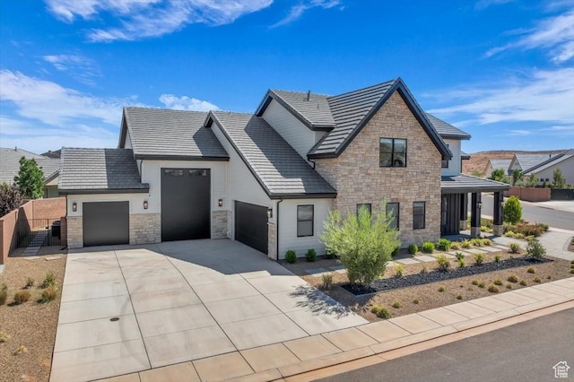 772 E Prairie Way, Washington, UT 84780 - view of front of house with stone siding, a garage, concrete driveway, a tiled roof, and stucco siding