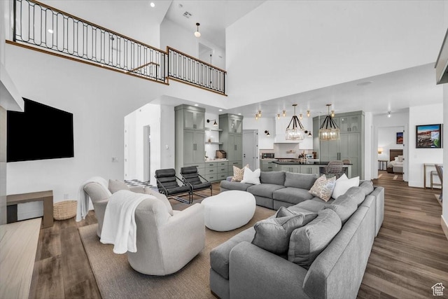 772 E Prairie Way, Washington, UT 84780 - living area with a chandelier, dark wood-style flooring, and a high ceiling