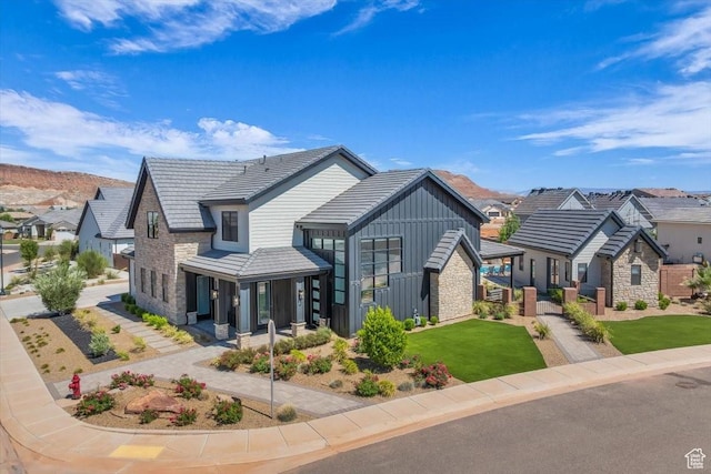 772 E Prairie Way, Washington, UT 84780 - view of front facade with board and batten siding, stone siding, a residential view, and a front lawn