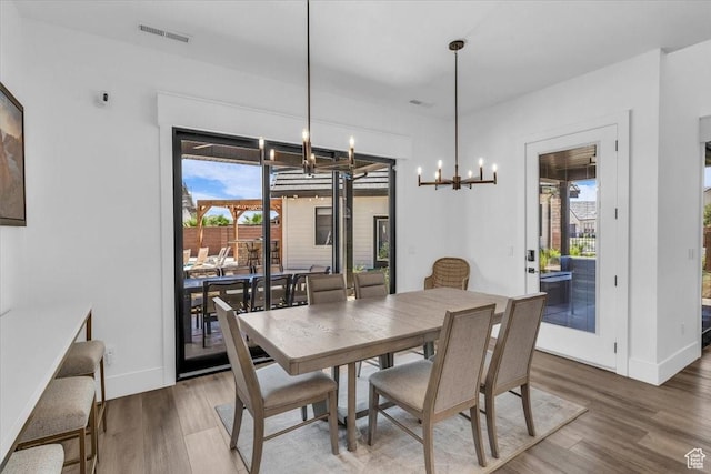 772 E Prairie Way, Washington, UT 84780 - dining area featuring healthy amount of natural light, wood finished floors, and a chandelier