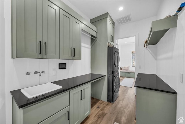 772 E Prairie Way, Washington, UT 84780 - laundry room featuring stacked washing machine and dryer, cabinet space, light wood-style flooring, and recessed lighting