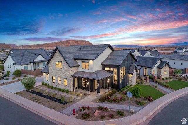 772 E Prairie Way, Washington, UT 84780 - view of front of property featuring stone siding, concrete driveway, a residential view, and covered porch