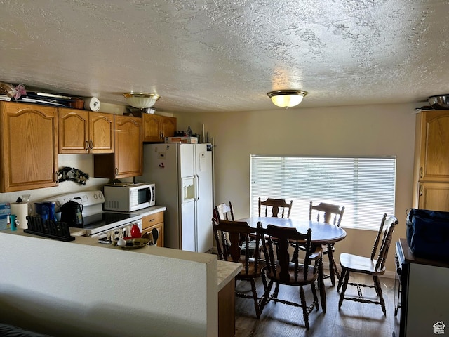 5223 N 930 E, Scofield, UT 84526 - kitchen featuring white appliances, brown cabinetry, light countertops, dark wood-style flooring, and a textured ceiling