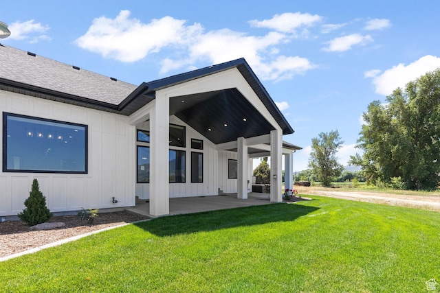3359 W 3500 S, Wellsville, UT 84339 - rear view of property featuring board and batten siding, a yard, a shingled roof, and a patio