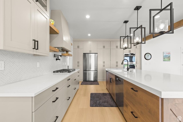 3359 W 3500 S, Wellsville, UT 84339 - kitchen with stainless steel appliances, light wood-style floors, tasteful backsplash, light countertops, and a spacious island