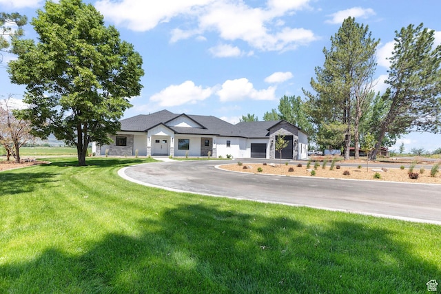 3359 W 3500 S, Wellsville, UT 84339 - modern farmhouse with asphalt driveway, a garage, and a front lawn