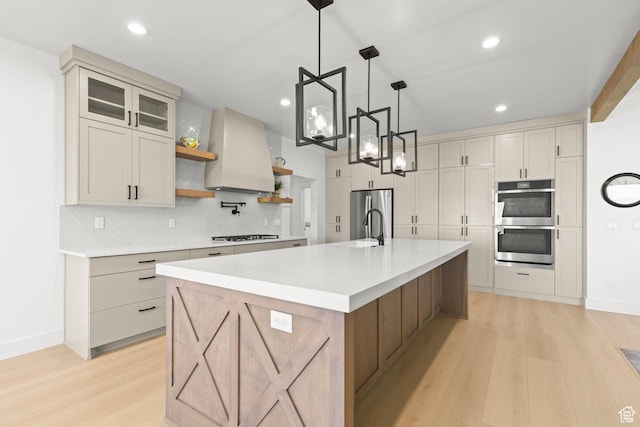 3359 W 3500 S, Wellsville, UT 84339 - kitchen featuring stainless steel appliances, custom exhaust hood, light wood-style flooring, open shelves, and backsplash