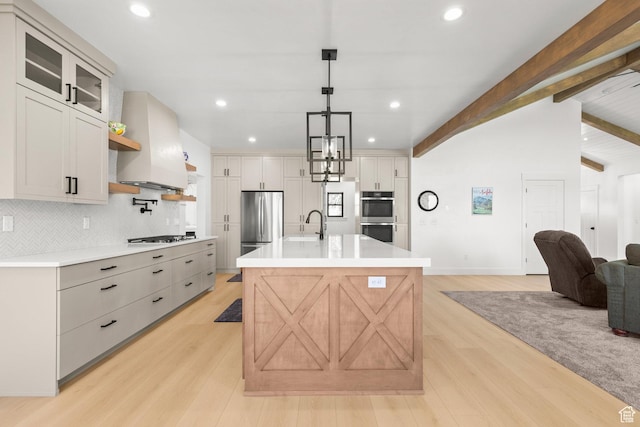 3359 W 3500 S, Wellsville, UT 84339 - kitchen with stainless steel appliances, wall chimney exhaust hood, light wood-type flooring, decorative backsplash, and light countertops