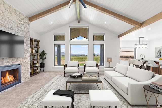 3359 W 3500 S, Wellsville, UT 84339 - living area with a fireplace, carpet flooring, plenty of natural light, ceiling fan, and beamed ceiling