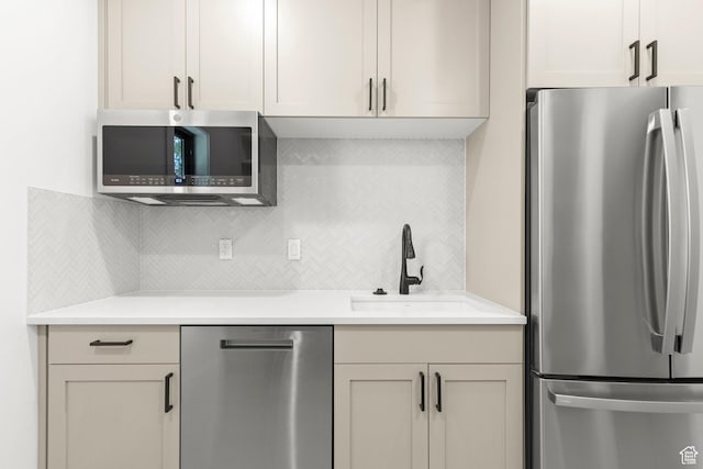 3359 W 3500 S, Wellsville, UT 84339 - kitchen featuring appliances with stainless steel finishes, backsplash, and light countertops