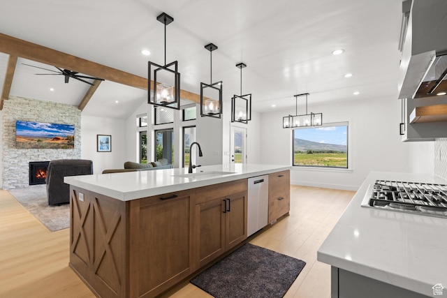 3359 W 3500 S, Wellsville, UT 84339 - kitchen with light wood-type flooring, appliances with stainless steel finishes, a fireplace, recessed lighting, and an island with sink