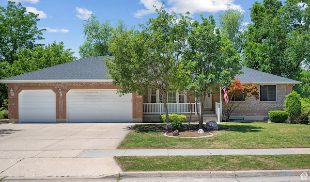 560 S 1350 E, Fruit Heights, UT 84037 - obstructed view of property with a garage, concrete driveway, brick siding, covered porch, and a front lawn