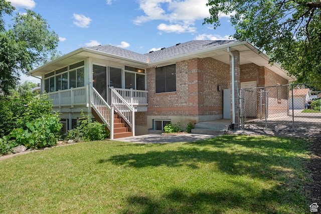 560 S 1350 E, Fruit Heights, UT 84037 - view of front facade featuring brick siding, a sunroom, roof with shingles, and a gate