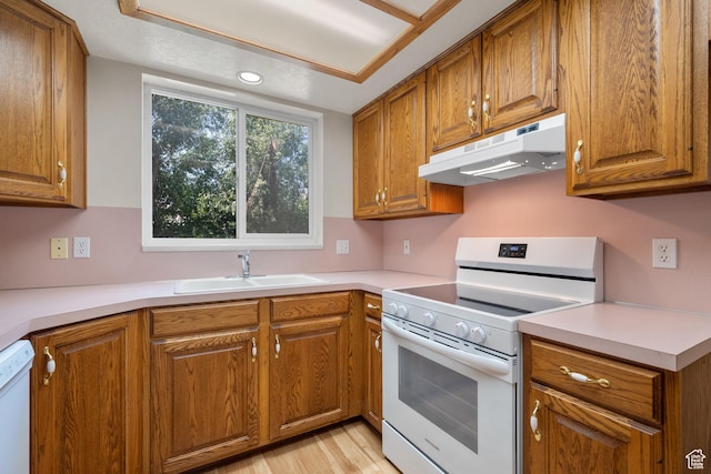 560 S 1350 E, Fruit Heights, UT 84037 - kitchen featuring white appliances, under cabinet range hood, and brown cabinetry