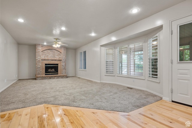 560 S 1350 E, Fruit Heights, UT 84037 - unfurnished living room with ceiling fan, recessed lighting, a brick fireplace, and hardwood / wood-style flooring