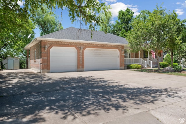 560 S 1350 E, Fruit Heights, UT 84037 - view of front facade with a garage, brick siding, driveway, covered porch, and a storage unit