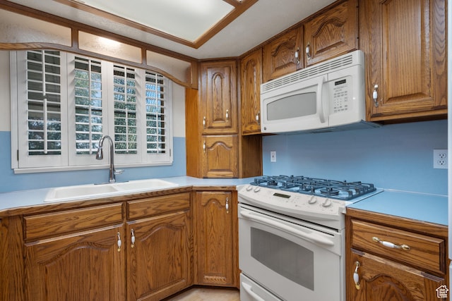 560 S 1350 E, Fruit Heights, UT 84037 - kitchen with white appliances, light countertops, and brown cabinets