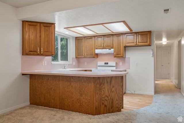 560 S 1350 E, Fruit Heights, UT 84037 - kitchen with under cabinet range hood, electric range, a peninsula, and brown cabinetry