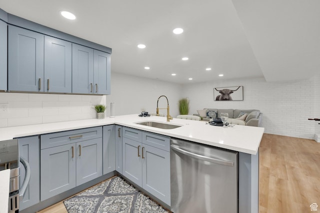 10852 S Starpine Dr, Sandy, UT 84094 - kitchen featuring dishwasher, a peninsula, recessed lighting, open floor plan, and light wood-style flooring
