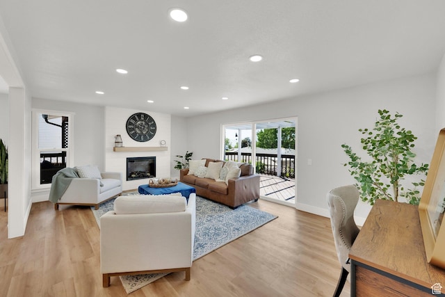 10852 S Starpine Dr, Sandy, UT 84094 - living area featuring a fireplace, light wood finished floors, and recessed lighting