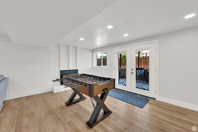 10852 S Starpine Dr, Sandy, UT 84094 - rec room with wood finished floors, brick wall, recessed lighting, and french doors