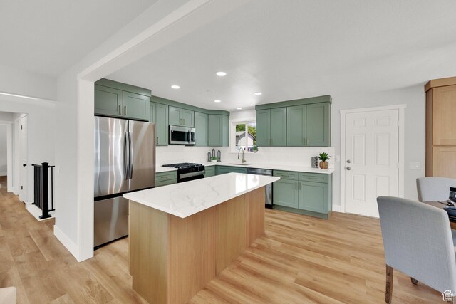 10852 S Starpine Dr, Sandy, UT 84094 - kitchen with green cabinets, appliances with stainless steel finishes, light wood finished floors, a kitchen island, and recessed lighting