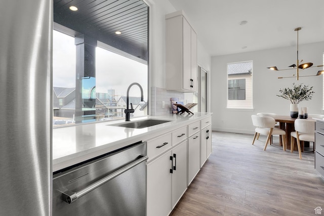 4269 N Maple Hollow Dr Unit 117, Lehi, UT 84043 - kitchen featuring stainless steel dishwasher, light wood-style floors, light countertops, white cabinetry, and recessed lighting