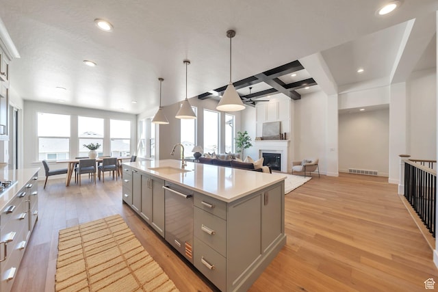 7991 S Ambrosia Ln, West Jordan, UT 84081 - kitchen featuring gray cabinets, dishwasher, coffered ceiling, light countertops, and light wood-style floors