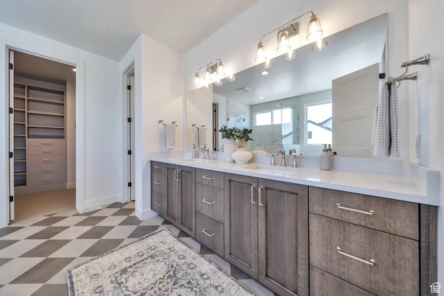 7991 S Ambrosia Ln, West Jordan, UT 84081 - bathroom with tile patterned floors, double vanity, a shower, and a spacious closet