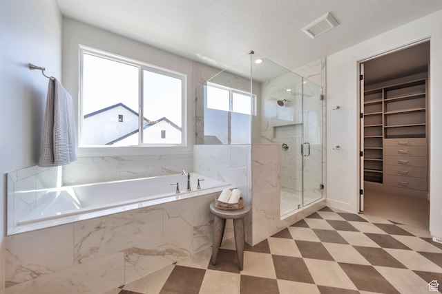 7991 S Ambrosia Ln, West Jordan, UT 84081 - full bath featuring a bath, a marble finish shower, a spacious closet, and tile patterned floors
