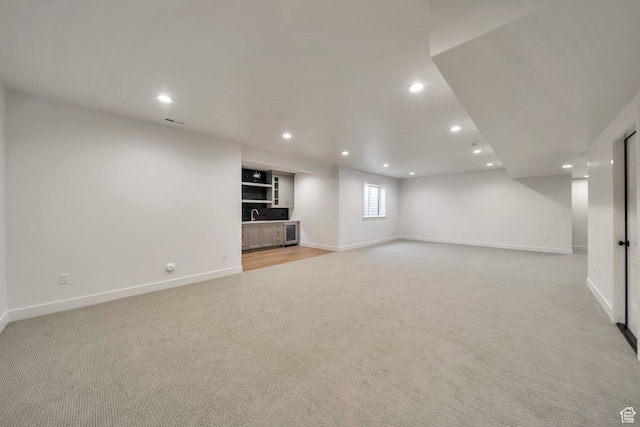 7991 S Ambrosia Ln, West Jordan, UT 84081 - unfurnished living room with light colored carpet, wet bar, and recessed lighting